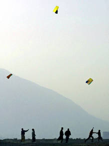 AFGHAN CHILDREN PLAY WITH KITES IN KABUL.