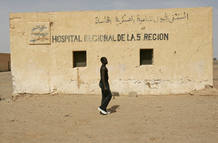 African would-be immigrant walks past a hospital in a Saharawi refugee camp in the Western Sahara