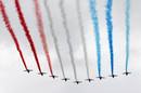 Alphajet planes from the Patrouille de France fly over the Champs Elysees as part of the traditional Bastille Day military parade in Paris