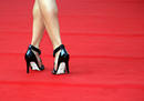 An unidentified guest arrives on the red carpet for the screening of the film 