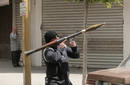 A Shi’ite opposition gunman takes position in a street in Beirut