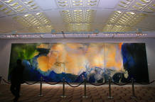 A visitor looks at a 2.8-metre by 10-metre triptych by Chinese painter Zao at Christie's auction ...