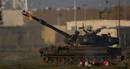 Israeli mobile artillery unit fires shell from its position outside Gaza Strip