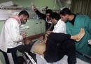Medics treat wounded Palestinian after Israeli air strike at mosque in northern Gaza Strip