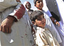 Afghan boys slightly wounded by a suicide attack wait for transport in Kabul