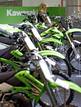 Una azafata permanece en el stand de la marca japonesa Kawasaki en la Feria MotOh!, certamen de referencia del mundo de la moto en Espa&ntilde;a