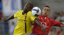Barcelonas Abidal and Numancias Anton fight for the ball during their Spanish First Division Soccer League match at Los Pajaritos stadium in Soria