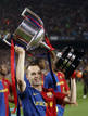 Barcelonas Andres Iniesta holds up the Spanish first division soccer league trophy at Camp Nou stadium in Barcelona