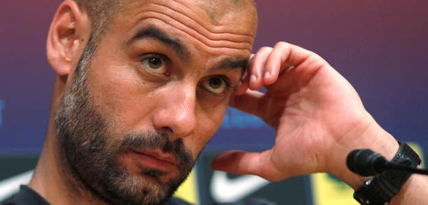 Barcelona's coach Pep Guardiola attends a news conference at Nou Camp stadium in Barcelona