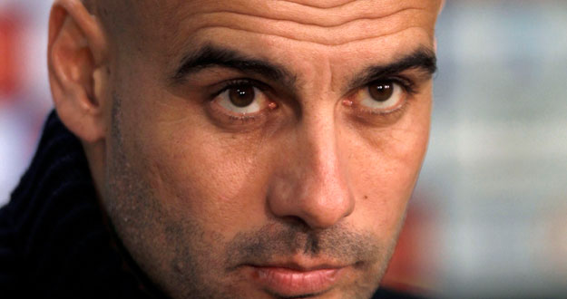 Barcelona's coach Pep Guardiola listens to a question during a news conference before their semi-final second leg soccer match against Valencia near Barcelona