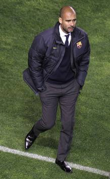 Barcelona's coach Pep Guardiola walks before their Spanish First division soccer league match against Rayo Vallecano at Vallecas stadium in Madrid