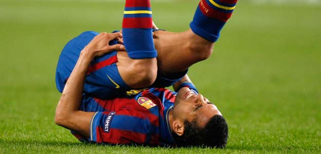 Barcelona's Dani Alves grimaces after being tackled by a Rubin Kazan player during their Champions League soccer match at the Camp Nou stadium in Barcelona Barcelona's Dani Alves grimaces after being tackled by a Rubin Kazan player during their Champions League soccer match at the Camp Nou stadium in Barcelona