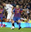 Barcelonas Iniesta is challenged by Real Madrids Benzema during their Spanish Kings Cup soccer match in Madrid