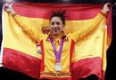 Silver medallist Spains Brigitte Yague Enrique holds up a national flag at the womens -49kg taekwondo victory ceremony during the London 2012 Olympic Games at the ExCeL arena
