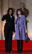 Frances first lady Carla Bruni-Sarkozy and U.S. first lady Michelle Obama wave as they arrive for the visit of the Strasbourgs Cathedral