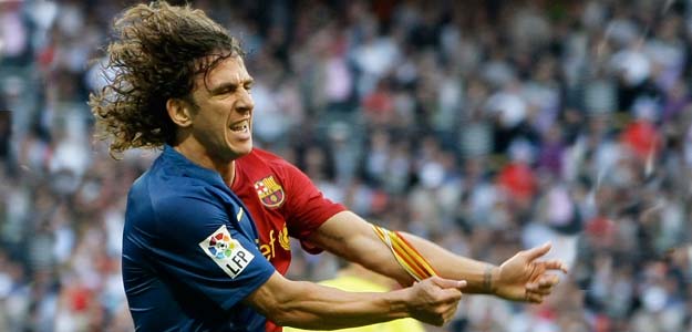 Barcelona's captain Puyol takes off his captain band as he celebrates his goal against Real Madrid during their Spanish first division soccer match in Madrid