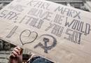 A demonstrator stands in front of the Credit Suisse building during the 