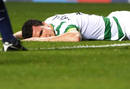 Celtics Caldwell lies face down on the pitch after he let in an own goal during their Champions League qualifying soccer match against Arsenal in Glasgow, Scotland