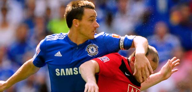 Chelsea's Terry challenges Manchester United's Rooney during their English Community Shield soccer match in London
