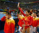 Cheng Fei of China celebrates with teammates after winning the womens team artistic gymnastics gold medal at the Beijing 2008 Olympic Games