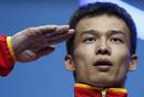 Chinas Jingbiao Wu salutes at the podium after getting silver medal on the mens 56Kg Group A weightlifting competition at the London 2012 Olympic Games