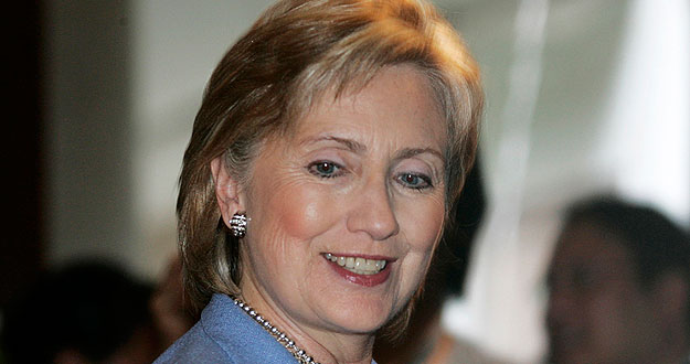 U.S. Secretary of State Hillary Clinton smiles as she leaves a press briefing during ASEAN ministerial meeting in Phuket