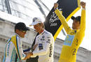 Astana rider and leaders yellow jersey Contador celebrates his overall victory as Saxo Bank rider and white jersey for best youngster Schleck shakes hands with Astana rider Armstrong after the final stage of the Tour de France cycling race