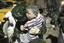 A boy is rescued from the debris of a collapsed building after an earthquake in Dujiangyan