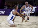 Czech Republics Premysl Kubala digs the ball for Petr Benes against Todd Rogers and Phil Dalhausser of the U.S. during their mens preliminary round beach volleyball match at Horse Guards Parade during the London 2012 Olympic Games