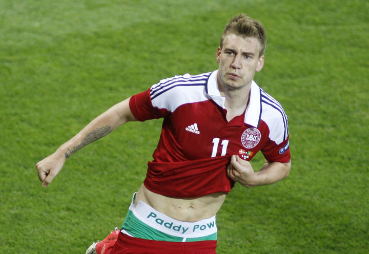 El delantero dan&eacute;s Nicklas Bendtner mostrando la publicidad en pleno partido.
