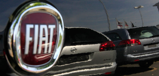 Two Opel cars are reflected in a Fiat car at a car seller in Darmstadt