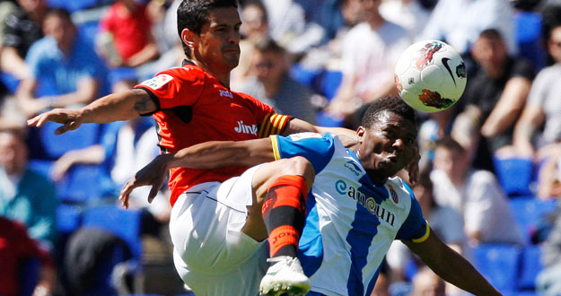 Espanyol's Uche fights for the ball with Valencia's Costa during their Spanish First division soccer league match near Barcelona