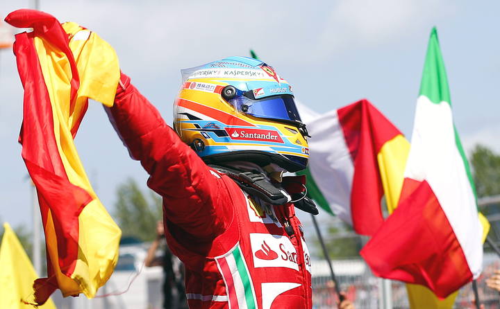Fernando Alonso celebra con la bandera de Espa&ntilde;a su triunfo.
