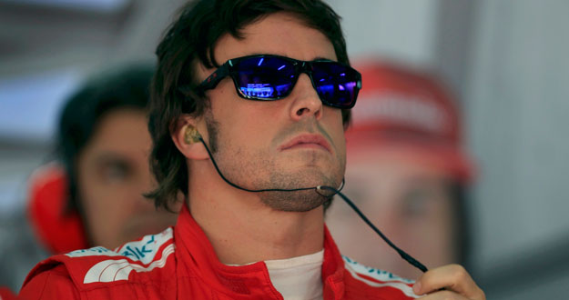 Ferrari Formula One driver Alonso looks at a monitor during the third practice session of the Bahrain F1 Grand Prix at the Sakhir circuit in Manama