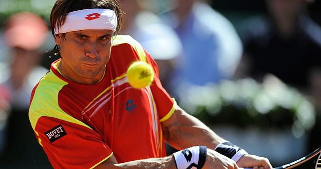 Ferrer of Spain returns a shot to Querrey of the U.S. during their Davis Cup World Group semi-final match in Gijon