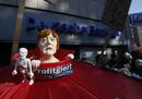A figure of German Chancellor Merkel is pictured during a protest of several hundred people against banking and finance in front of a branch of Germanys largest bank Deutsche Bank in Cologne