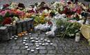 Flowers and candles are placed on the market square outside the Oslo cathedral to mourn the victims of a bomb blast and a rampage
