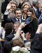 Frances President and UMP party candidate for the 2012 French presidential elections Nicolas Sarkozy arrives with Frances first lady Carla Bruni-Sarkozy at a voting station in Paris