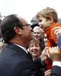 Frances President Hollande kisses a child as he attends an anniversary ceremony of a reconciliation meeting after World War II, in Reims