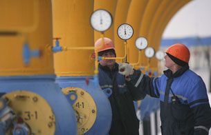 Workers check the pressure at the Nesvizhskaya gas compressor station near Minsk