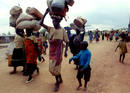 Rwandan refugees walk from their camp of Benaco in Tanzania towards the Rwandan border on their way ..