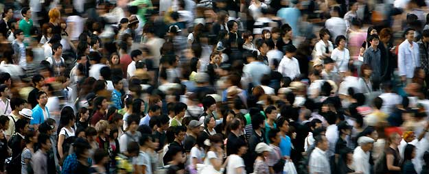 People walk across a street in Tokyo