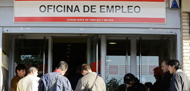 People line up to enter a government job centre in Madrid
