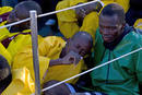 Would-be immigrants sit aboard a Spanish civil guard boat at the port of Arguineguin in Spains Canary Island of Gran Canaria