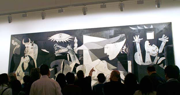 Visitors look at Spanish artist Picasso's "Guernica" in Madrid
