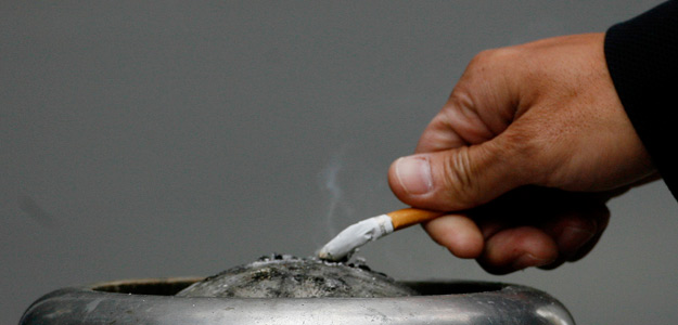 A man extinguishes his cigarette in central Sydney