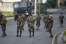 Honduran soldiers block a street near the residence of Honduras President Manuel Zelaya in Tegucigalpa