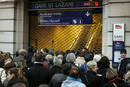Commuters wait for the opening of the Gare Saint Lazare train station in Paris