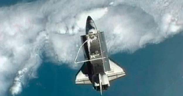 Image taken from NASA TV shows Space shuttle Atlantis pictured against the Earth