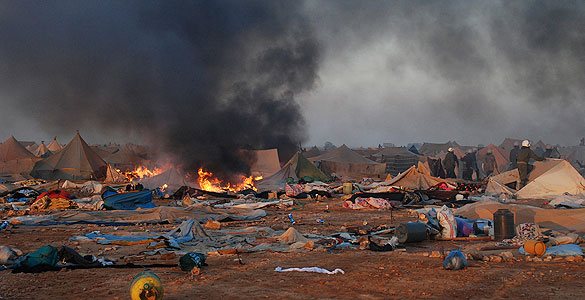 Tent burns after Moroccan security forces broke up the tent camp on the outskirts of Western Sahara's capital, Laayoune Tent burns after Moroccan security forces broke up the tent camp on the outskirts of Western Sahara's capital, Laayoune